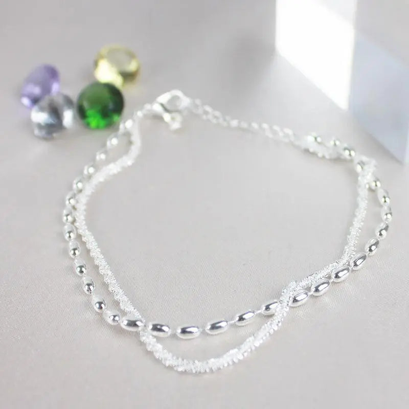 Conjunto de pulseras elegantes plateadas con piedras de circonia
