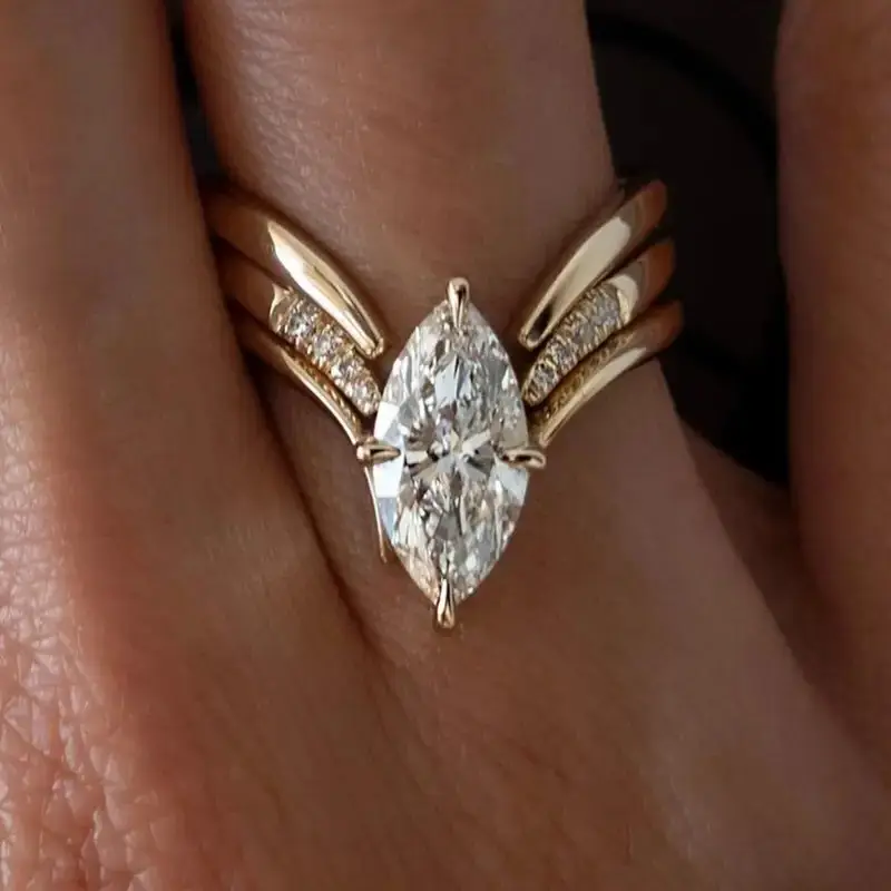 Anillo dorado con diseño de corona y gota
